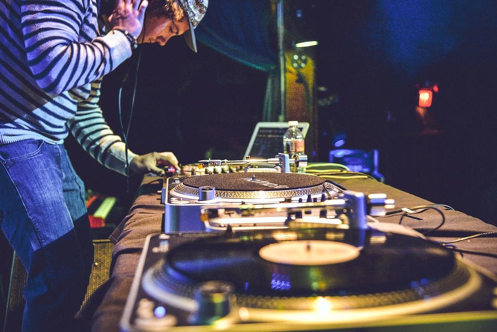 Electronic music DJ performing with spectacular light show and fog effects