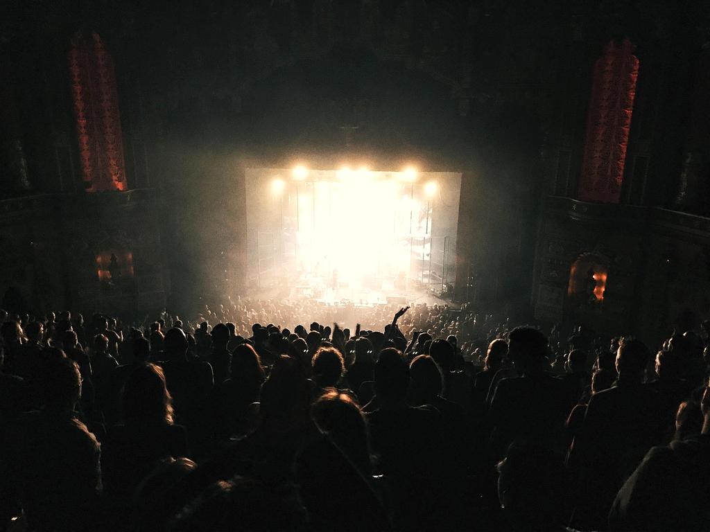 Live concert performance with colorful stage lights and excited crowd